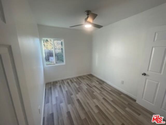 empty room featuring ceiling fan and hardwood / wood-style floors