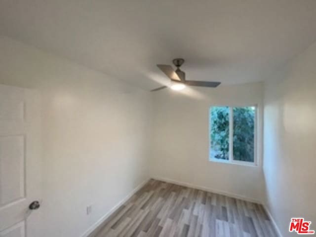 unfurnished room featuring light wood-type flooring and ceiling fan