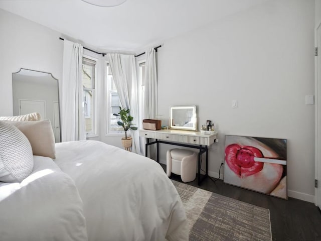 bedroom with dark wood-type flooring