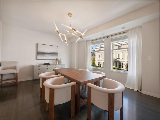 dining area featuring dark hardwood / wood-style flooring and a chandelier