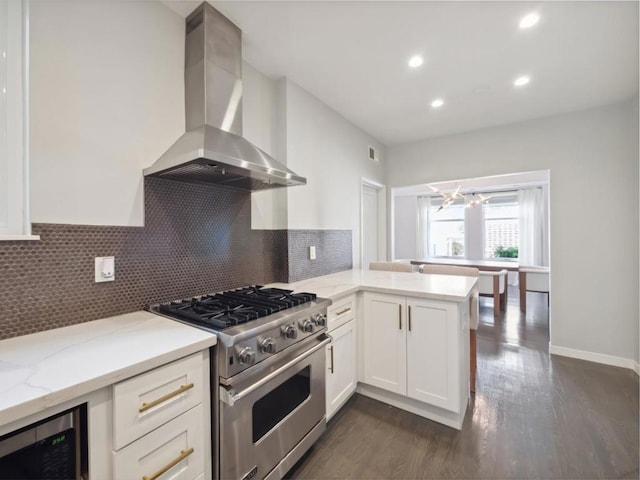 kitchen with beverage cooler, range hood, high end stove, kitchen peninsula, and white cabinets