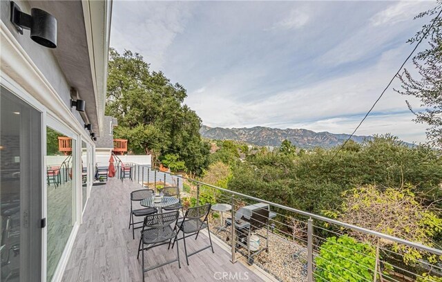 deck with a mountain view and grilling area