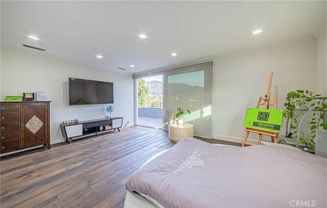 bedroom with hardwood / wood-style floors, access to exterior, and ornamental molding