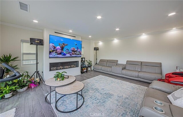 living room with hardwood / wood-style floors and crown molding