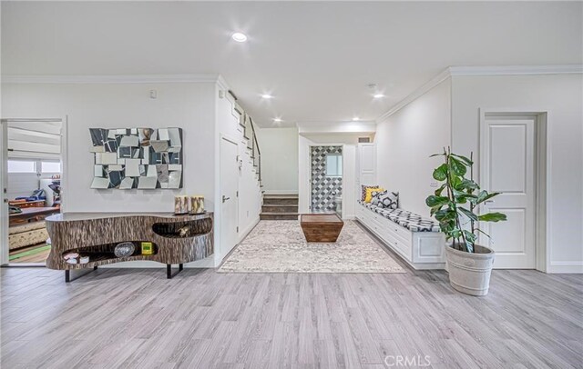 interior space featuring light hardwood / wood-style floors and crown molding