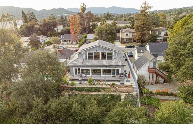 back of property with a mountain view and a balcony