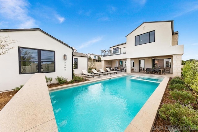 back of house featuring a patio area and a balcony