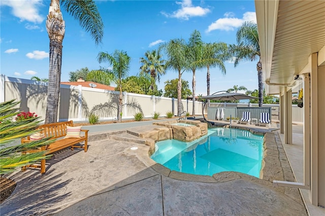 view of pool featuring a patio area, a fenced backyard, a fenced in pool, and an in ground hot tub