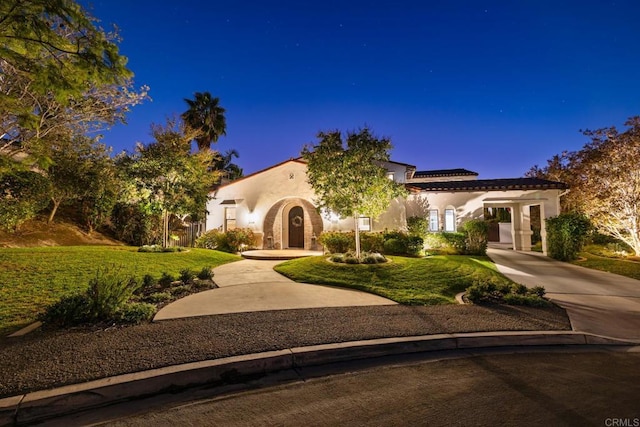 mediterranean / spanish home with a front lawn