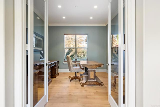 home office featuring light wood-type flooring, ornamental molding, and french doors