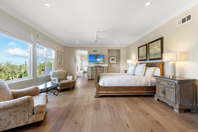 bedroom featuring ceiling fan, light hardwood / wood-style floors, and crown molding