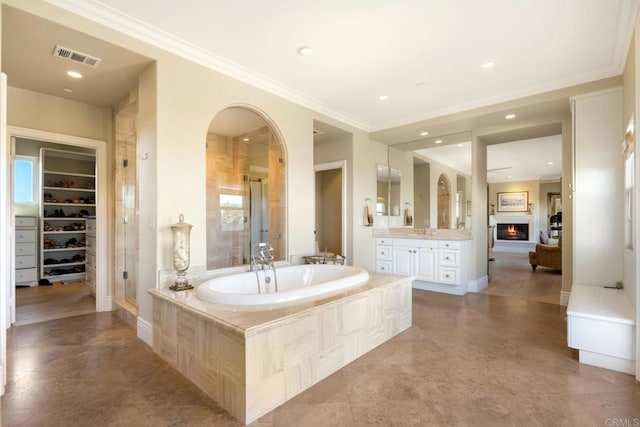 bathroom with built in shelves, vanity, ornamental molding, and independent shower and bath