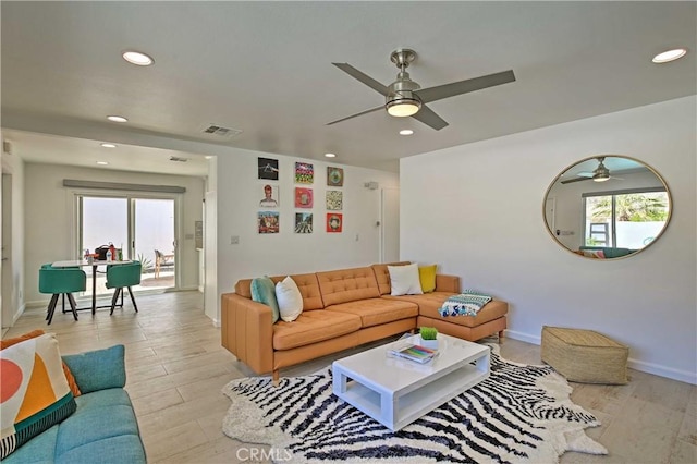 living room featuring ceiling fan and light hardwood / wood-style flooring