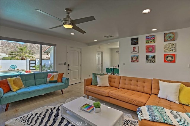 living room with ceiling fan and light wood-type flooring