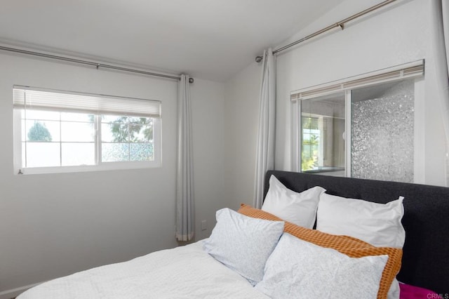 bedroom with lofted ceiling