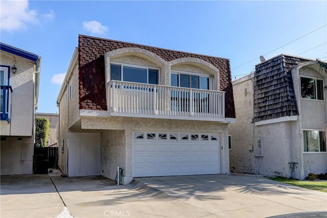 view of front facade with a balcony and a garage