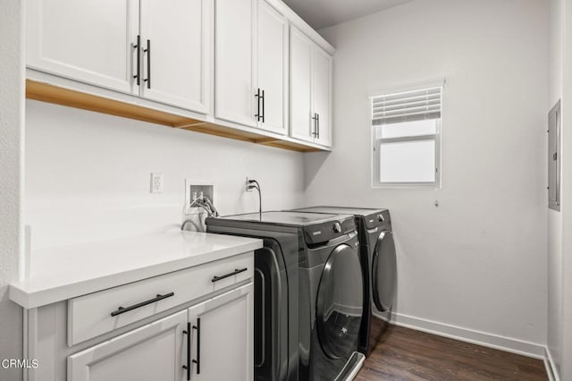 clothes washing area featuring cabinets, electric panel, dark hardwood / wood-style flooring, and independent washer and dryer