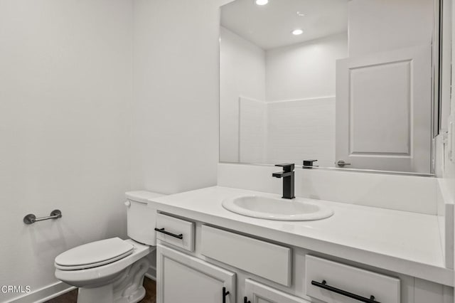 bathroom featuring toilet and vanity