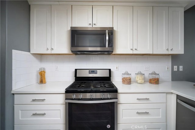 kitchen featuring backsplash, white cabinetry, and stainless steel appliances