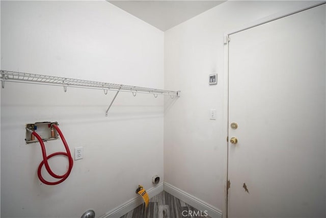 laundry area with hookup for a washing machine and hardwood / wood-style floors