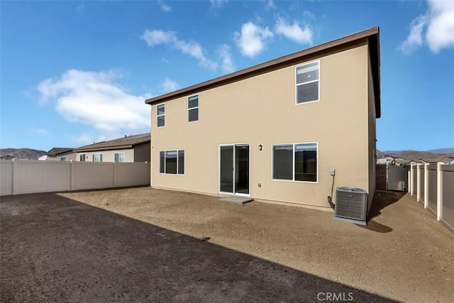 rear view of house featuring central AC