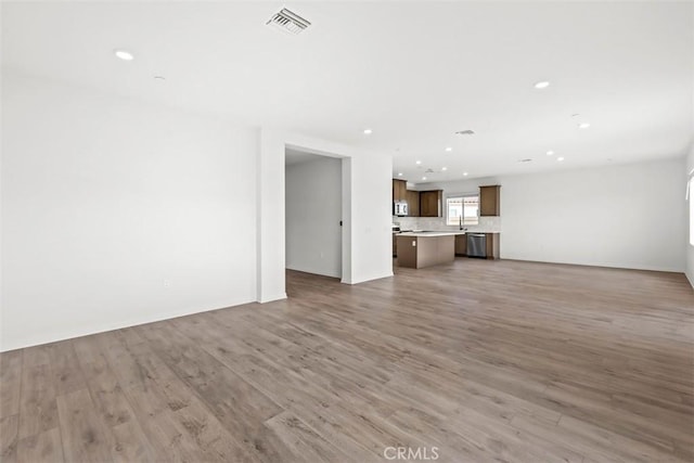 unfurnished living room featuring hardwood / wood-style floors