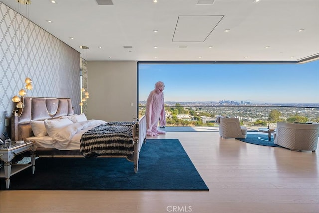 bedroom featuring light hardwood / wood-style flooring and floor to ceiling windows