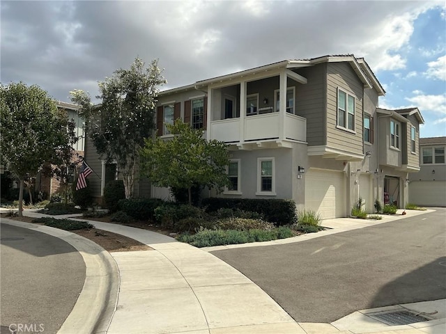 multi unit property featuring a balcony and a garage