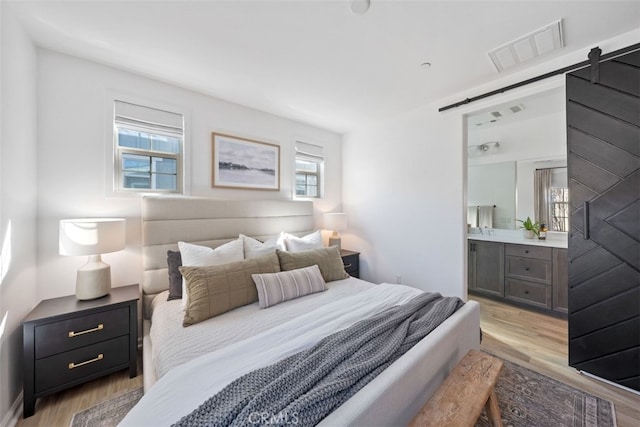 20 Jaripol Cir, Rancho Mission Viejo, CA 92694 - bedroom featuring a barn door, multiple windows, visible vents, and light wood-type flooring