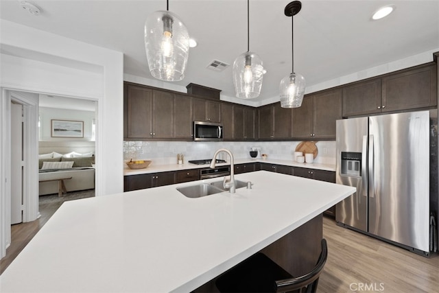 20 Jaripol Cir, Rancho Mission Viejo, CA 92694 - kitchen with visible vents, a sink, appliances with stainless steel finishes, light countertops, and dark brown cabinets