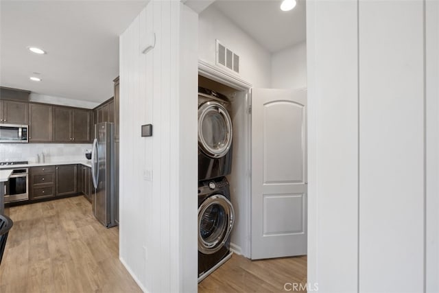 20 Jaripol Cir, Rancho Mission Viejo, CA 92694 - clothes washing area featuring visible vents, laundry area, recessed lighting, stacked washer and clothes dryer, and light wood-type flooring