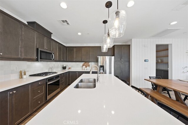 20 Jaripol Cir, Rancho Mission Viejo, CA 92694 - kitchen featuring a sink, dark brown cabinetry, light countertops, and stainless steel appliances