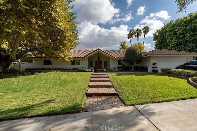 view of front of home with a garage and a front yard