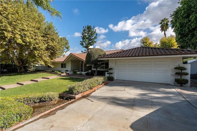 view of front of house featuring a garage and a front lawn