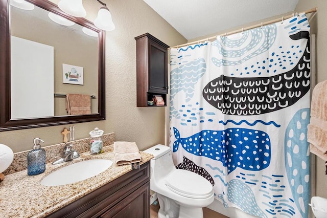 bathroom with a shower with curtain, vanity, and toilet