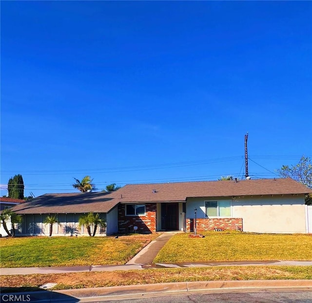 ranch-style home featuring a front yard