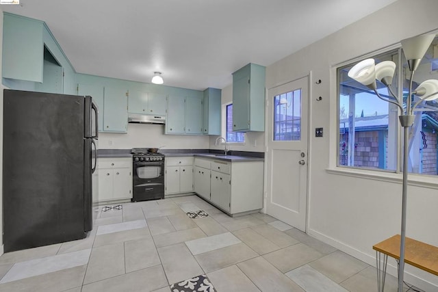 kitchen featuring light tile patterned flooring, sink, and black appliances