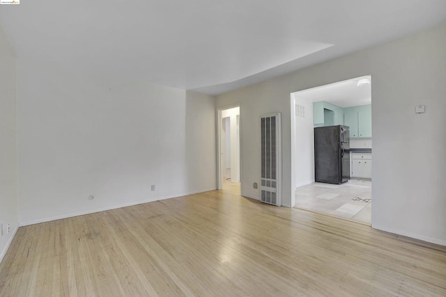 empty room with light wood-type flooring