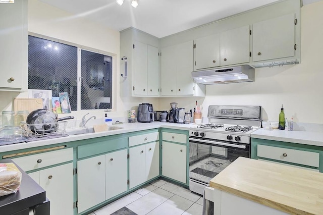 kitchen featuring gas stove and light tile patterned floors