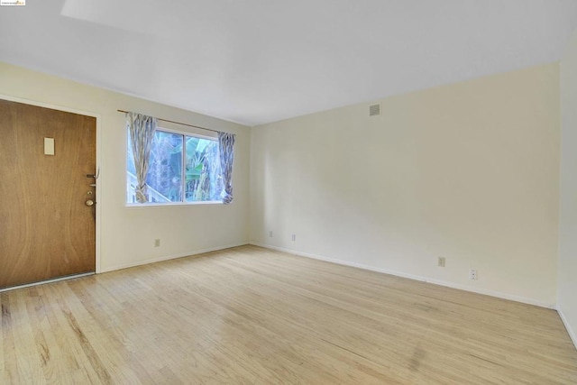 spare room with light wood-type flooring