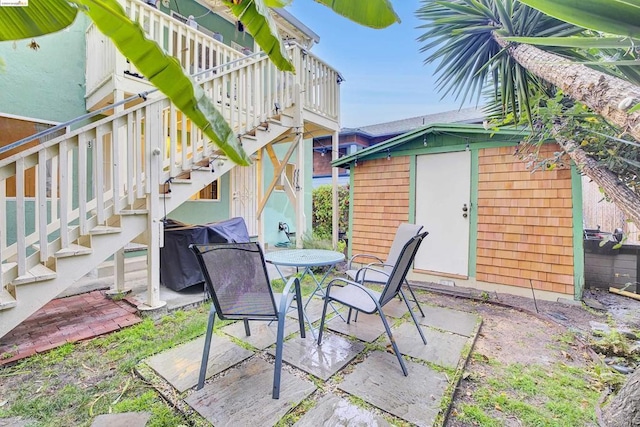 view of patio with a storage shed