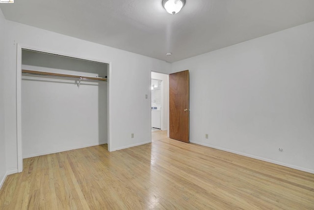 unfurnished bedroom featuring a closet and light hardwood / wood-style flooring