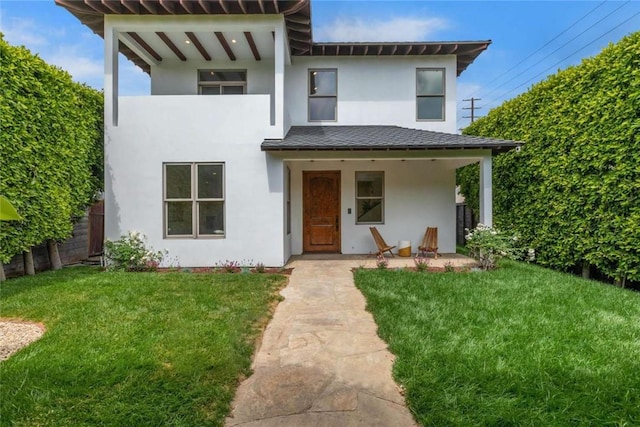 view of front facade with a front lawn and a patio