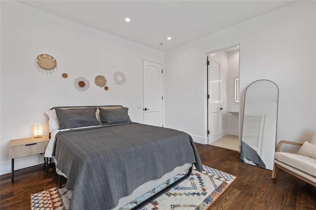 bedroom with dark wood-type flooring and ensuite bathroom