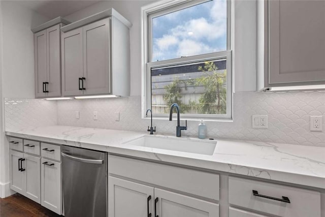 kitchen with sink, dark wood-type flooring, white cabinets, and light stone counters