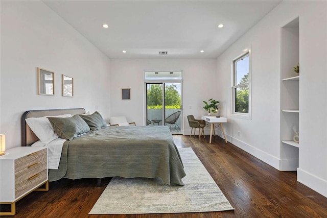 bedroom with access to exterior and dark wood-type flooring