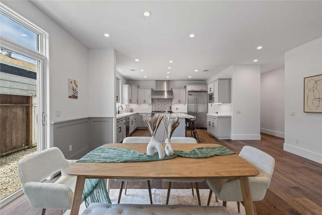 dining area with hardwood / wood-style flooring and sink