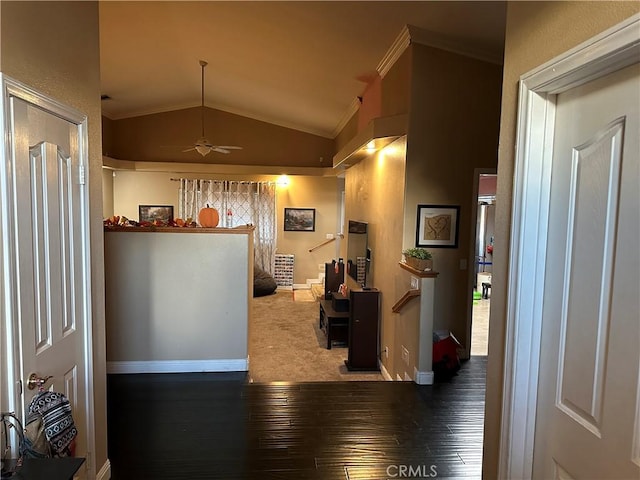 interior space featuring plenty of natural light, wood-type flooring, vaulted ceiling, and ornamental molding