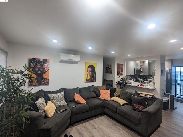 living room with light wood-type flooring and a wall mounted AC