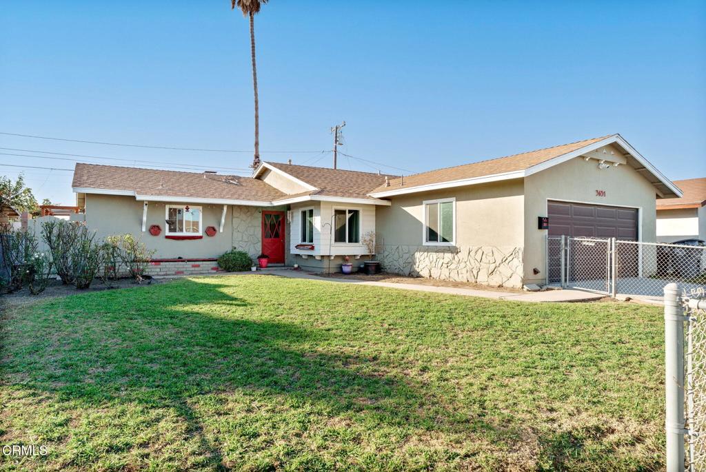 ranch-style home featuring a garage and a front yard